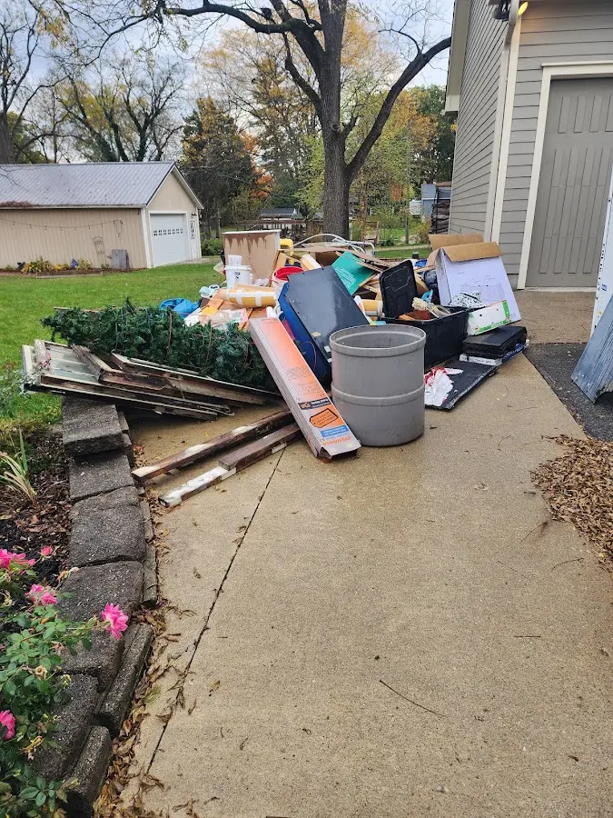 Dumpster being loaded with debris for Estate Cleanout Dumpster Rental in Santa Ana